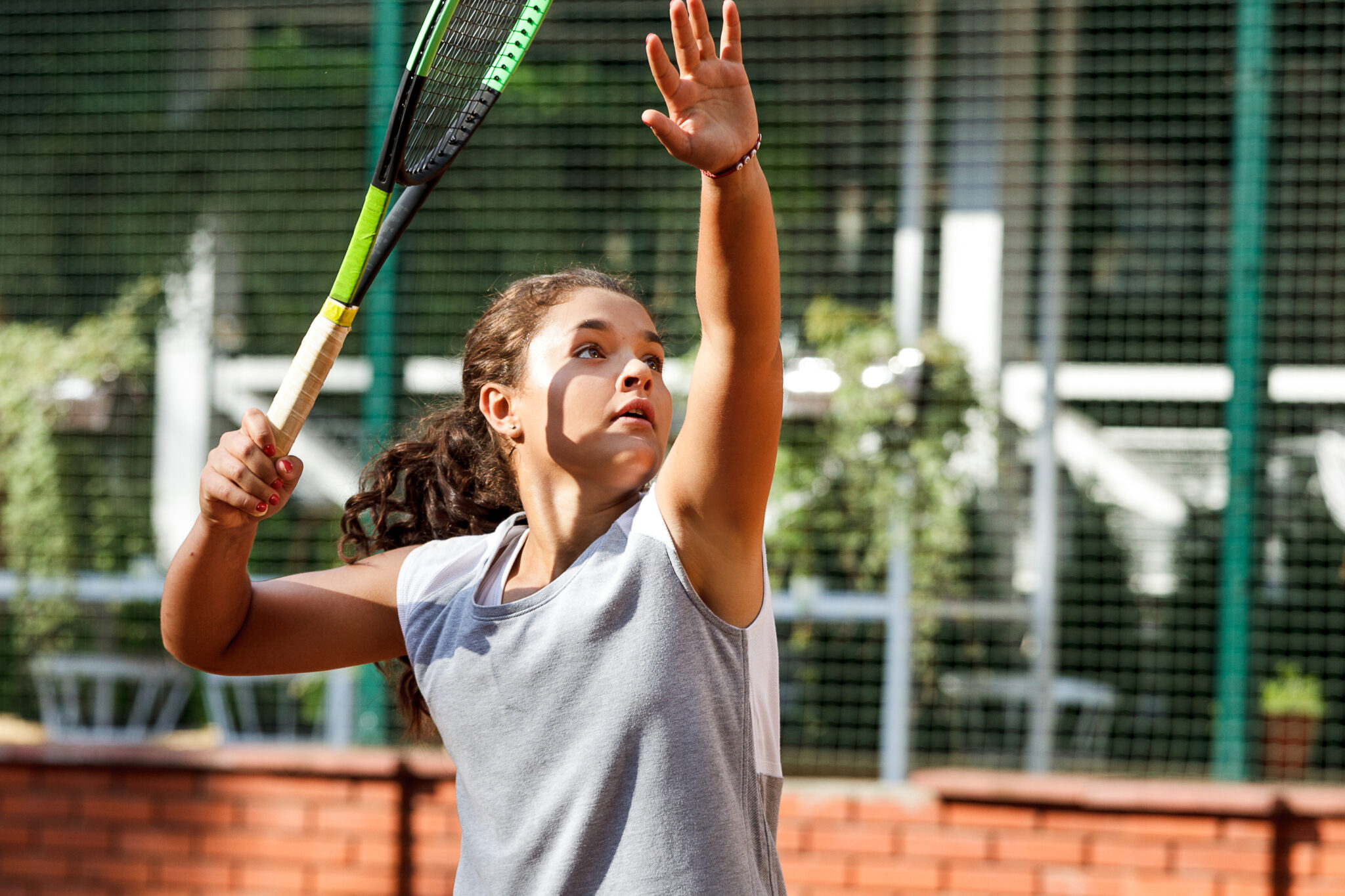 teenager tennis player girl training court girl racket ball brunette long hair sun portrait learn green summer green